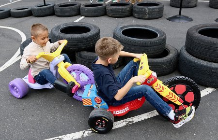 A pair of youngsters race their tricycles around an MIQ course on Sunday afternoon.